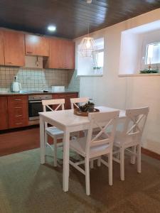 a white dining room table and chairs in a kitchen at Holiday Home Dunja in Opatija