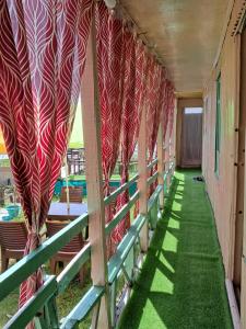 a hallway with red and white curtains on a train at LakeSide Homestay Srinagar in Srinagar
