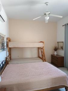 a bedroom with a bunk bed and a ceiling fan at Rose's House in Grótta +59 photos