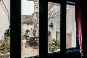 a window view of a patio with a table and chairs at Will Hay House - Large Georgian house in central Ramsgate in Kent