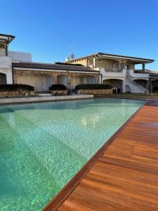 a swimming pool in front of a house at Sardinia Gold Luxury Apartment in Palau