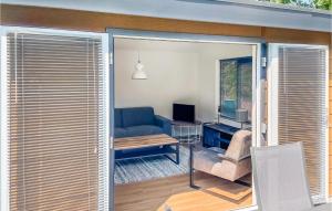 een woonkamer met een blauwe bank en een raam bij Gorgeous stacaravan In Putten With Wifi in Putten
