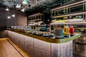 a long counter with plates of food on it at O11 Boutique Hotel Vienna in Vienna