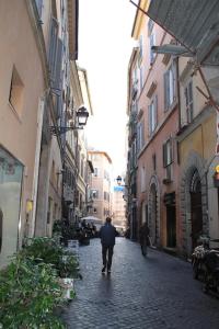 a man walking down a street in an alley at Annemary Maison in Rome