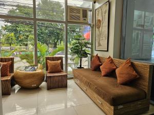 a living room with a couch and two chairs at Cebu Capitol Central Hotel & Suites powered by Cocotel in Cebu City