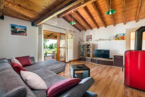 a living room with a couch and a tv at House Boris in Loborika