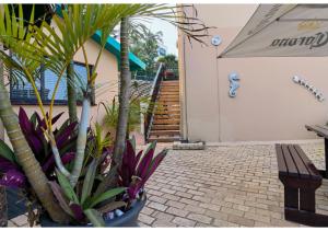 a bench sitting in front of a building with plants at Ocean View Villas in Ballito