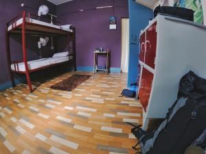 a room with two bunk beds and a wooden floor at Stargaze Backpackers Hostel in Guwahati