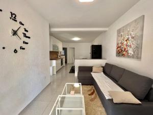 a living room with a couch and a table at Apartmani Ana in Dramalj
