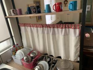 a kitchen counter with a sink and a curtain at 安禾居 AnHeJu B&B in Miaoli