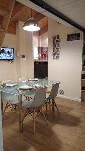 a dining room with a glass table and chairs at La Rovettina in Verolanuova