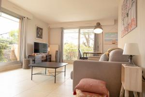 a living room with a couch and a table at Moana Haven Biarritz - Plages - Golf - WIFI - Standing in Anglet