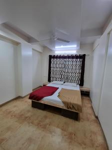 a bedroom with a large bed in a room at Sai Anand in Nashik