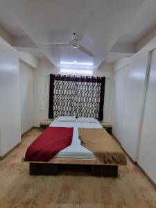 a bedroom with a large bed in a room at Sai Anand in Nashik