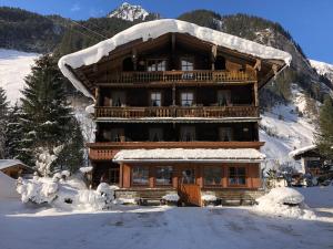 a large wooden building covered in snow at Haus Eder in Ginzling