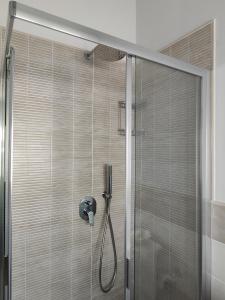 a shower with a shower head in a bathroom at Casa Violina in Lido di Camaiore