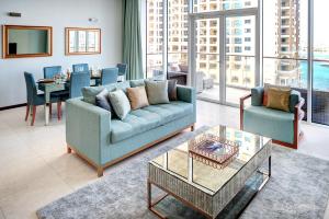 a living room with a couch and a table at Dream Inn Apartments - Tiara in Dubai