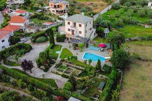 an aerial view of a house with a yard at Iris Villa with Swimming Pool in Áno Lekhónia