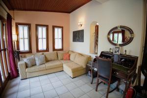 a living room with a couch and a table at Iris Villa with Swimming Pool in Áno Lekhónia