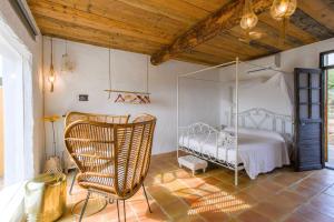 a bedroom with a white bed and a chair at LAS MARIPOSAS in San Antonio