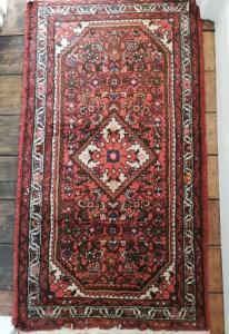 a rug on a wooden floor with a red carpet at Large Sunny King-Size En-Suite in Hastings