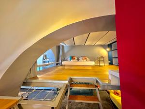 an archway in a room with a bed and a couch at Trastevere Loft in Rome
