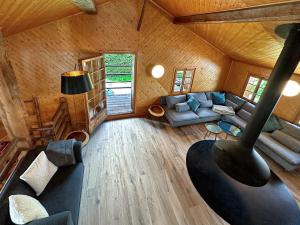 a living room of a log cabin with a couch at Chalet Karibu - 4 Vallees - A 20 mns de Verbier in Bruson
