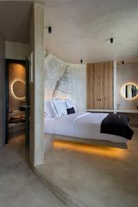 a bedroom with a large bed in a room at Senses Luxury Houses in Fira