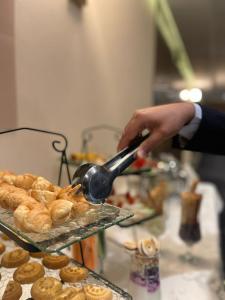 a person is making pastries on a buffet at Oriental Residence in Dammam