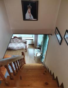 a room with a staircase with a picture of a queen at Gabriel Villa in Jeongseon