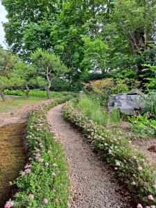 a gravel path with flowers and trees in a park at Gabriel Villa in Jeongseon