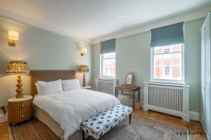 a bedroom with a white bed and two windows at The Long Walk: 3Bed & Garden in Windsor