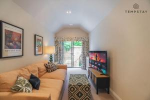 a living room with a couch and a flat screen tv at The Long Walk: 3Bed & Garden in Windsor