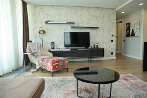 a living room with a couch and a tv at Deluxe 2BR Apartment Balcony 420 in Istanbul