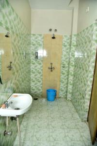 a bathroom with a sink and a shower at Bluebells Varanasi in Varanasi