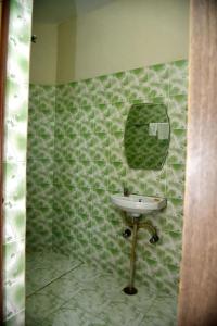 a bathroom with a sink and a mirror on a wall at Bluebells Varanasi in Varanasi