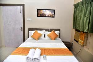 a bedroom with a bed with two towels on it at Bluebells Varanasi in Varanasi
