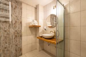 a bathroom with a sink and a glass shower at Aya Butik Otel in Istanbul