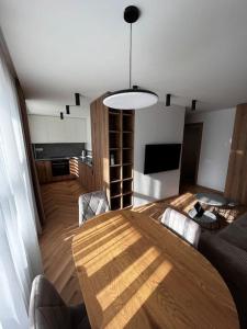 a living room with a wooden table and a dining room at Apartment in the old town in Kėdainiai