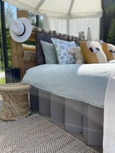 a bedroom with a bed with pillows and a rug at Glaspavillon minimaya in Obergesteln