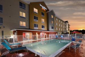 un hotel con piscina frente a un hotel en TownePlace Suites by Marriott Houston Westchase en Houston