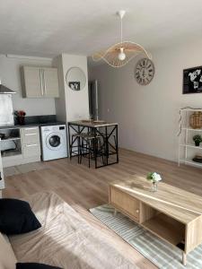 a living room with a table and a kitchen at Appartement port de Vannes in Vannes
