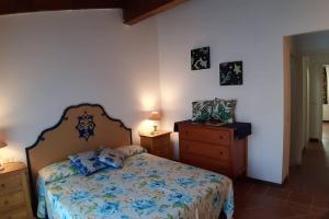 a bedroom with a bed and two night stands and a dresser at Casa Ethno Stintino-Private pool in Stintino +56 photos