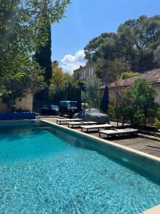 a swimming pool with two loungers and a swimming pool at Villa pont du Gard 4 Bedrooms in Remoulins