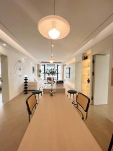 a large wooden table in a living room with chairs at Three Bedroom Apartment near Xintiandi in Shanghai