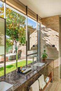 a bathroom with a sink and a large window at Vaya Beach Resort in Emona