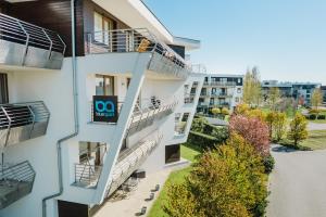 an apartment building with a balcony with a go sign on it at BlueApart Apartamenty Na Klifie in Władysławowo