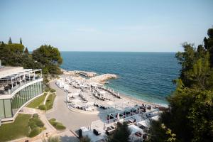 a view of a beach with chairs and the ocean at Skiper Apartments & Golf Resort in Savudrija