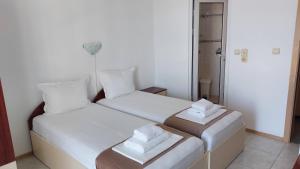 Postel nebo postele na pokoji v ubytování Krai Moreto Guest House