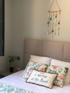 a bed with a pillow that says is better at the back at Villa neuve avec piscine in Bonifacio